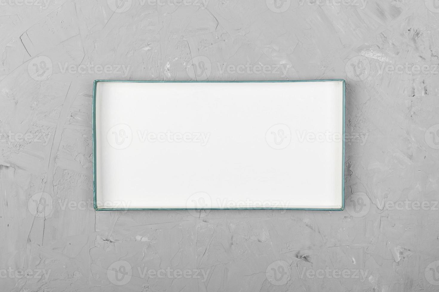 White rectangular empty open box, top view on white wooden background. top view photo