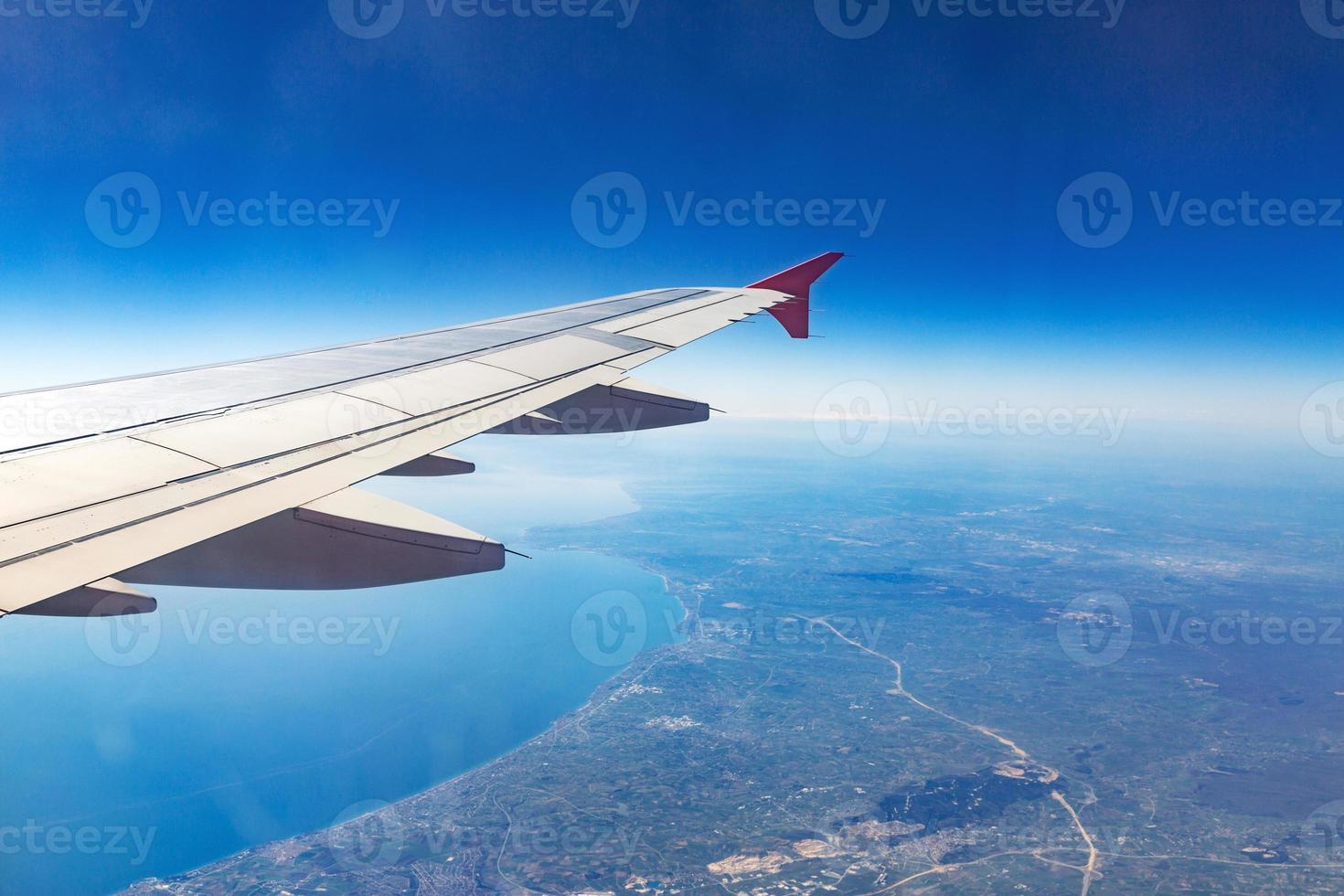 Wing of an airplane. Traveling concept. Aircraft wing on the clouds photo