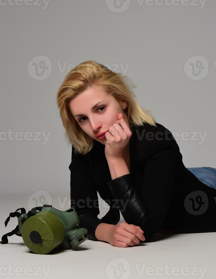 Sitting woman in gas mask photo