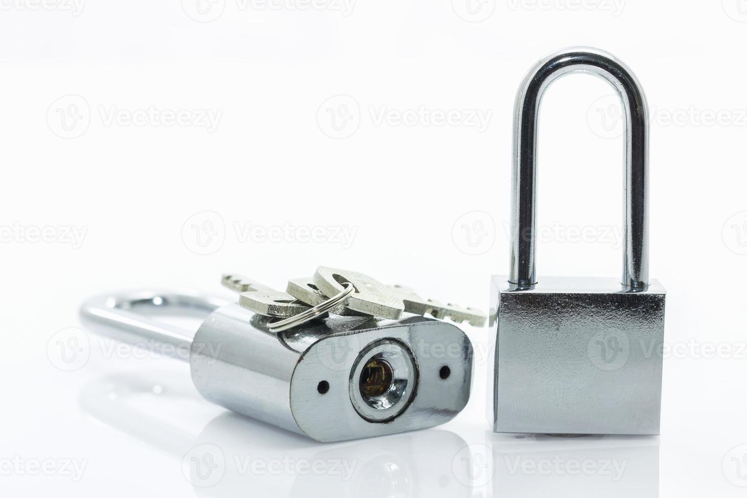 Metallic padlock with  keys on white background photo