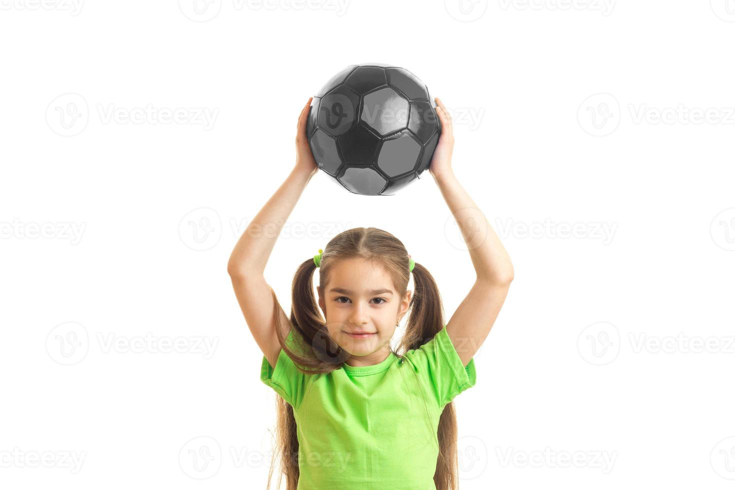 little girl lifted her head over the ball photo