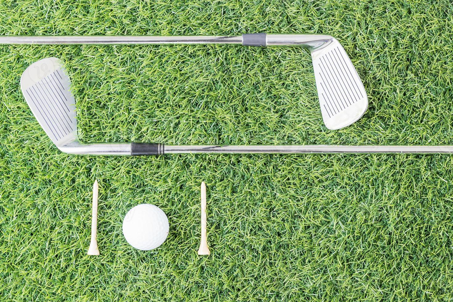 Golf club and Golf ball on green grass photo