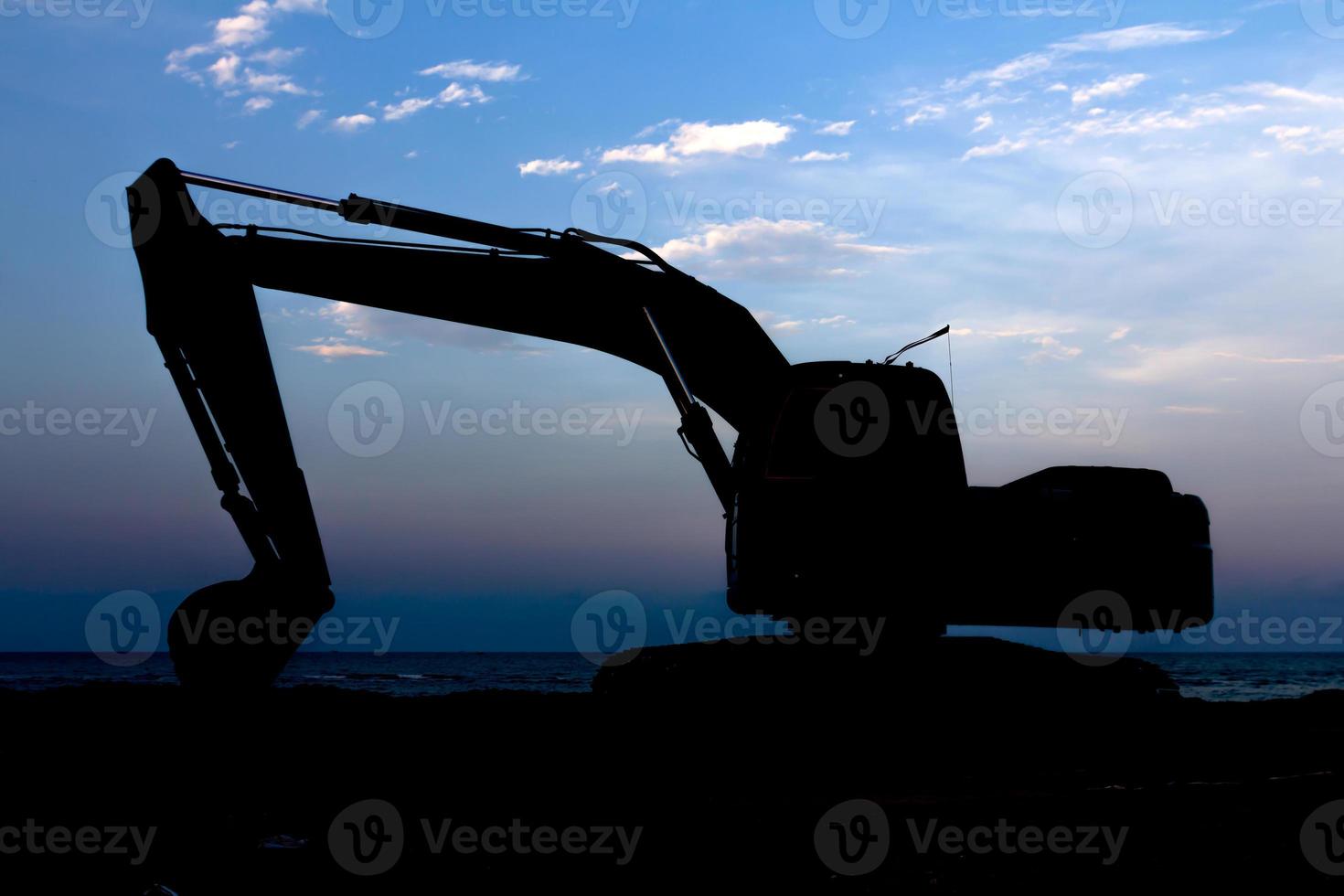 Excavator silhouette agent blue sky photo