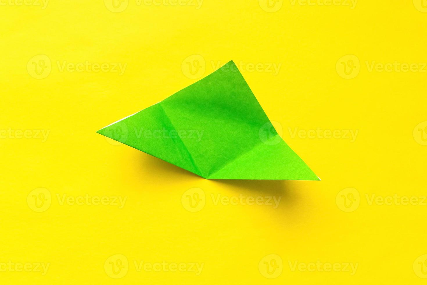 Step by step photo instruction how to make origami paper bookmark frog. Simple diy with kids children's concept.