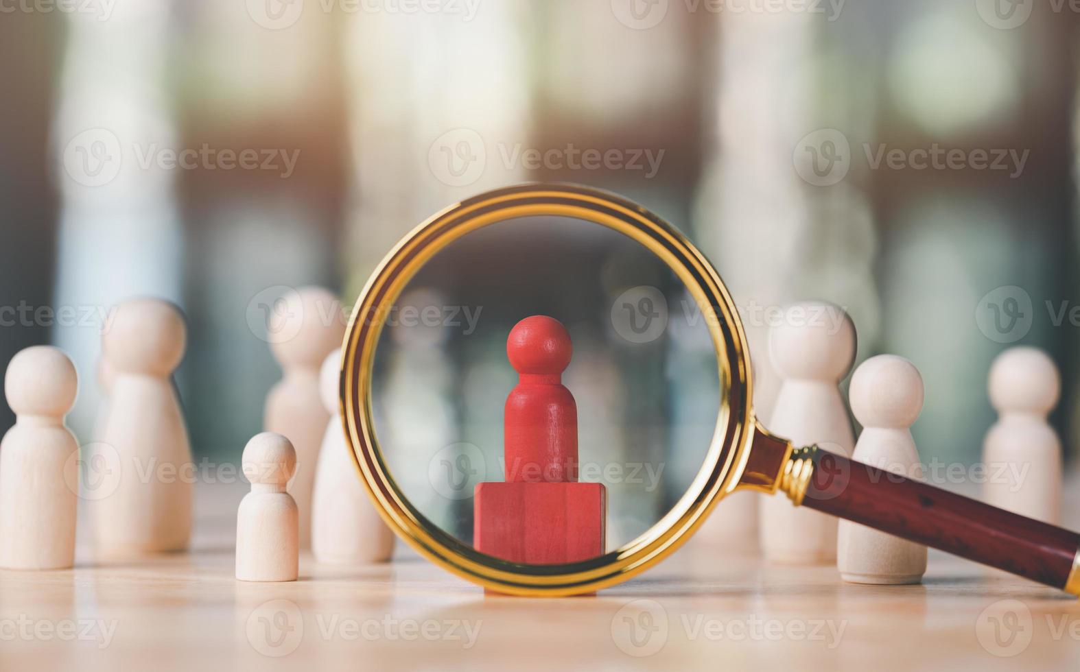 magnifying glass and a wooden doll are placed on table,HRM or Human Resource Management,leadership in recruitment,Business development by choosing professional leaders employee competency teamwork photo