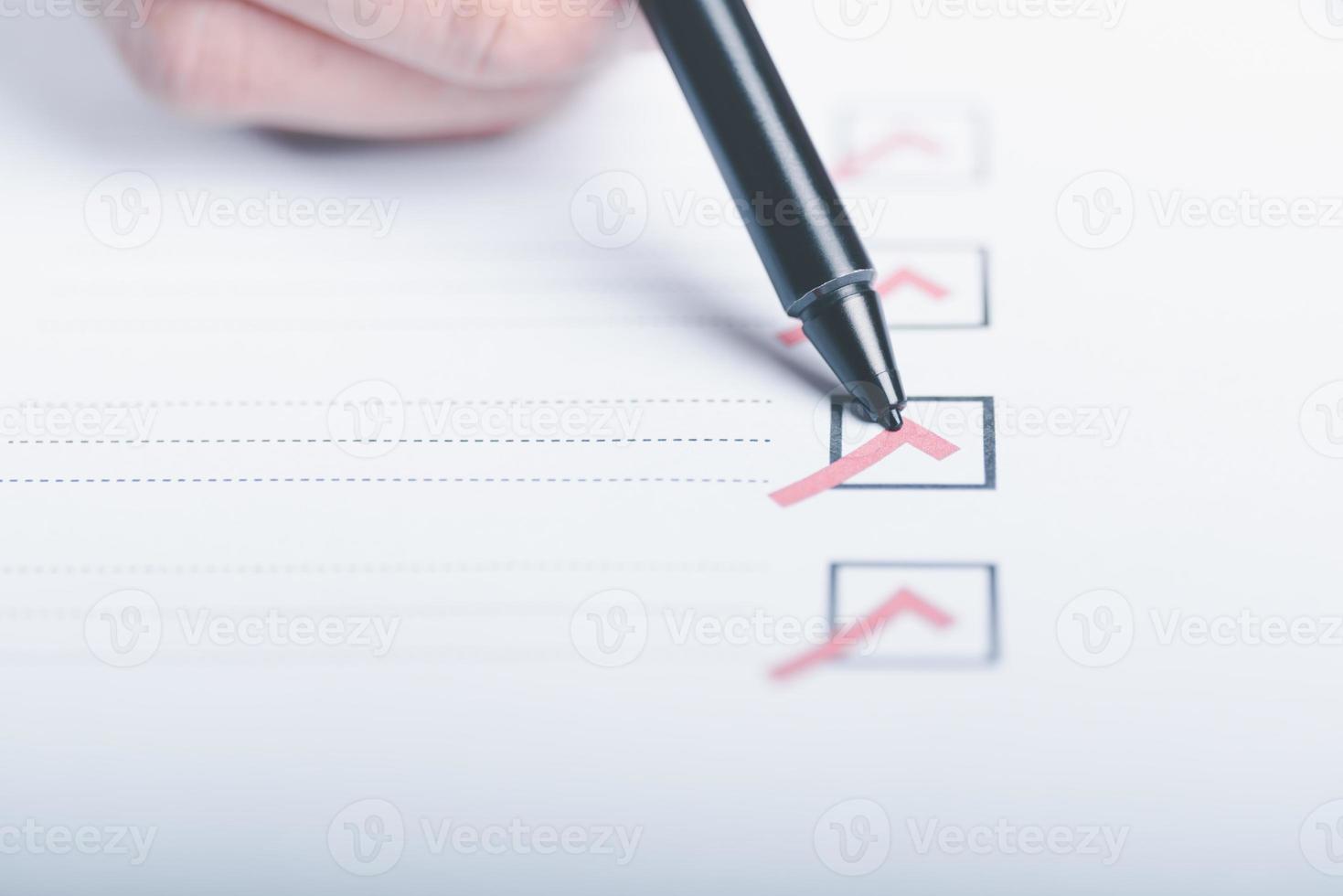 human hand check mark on paper,check concept through checkboxes, surveys through questionnaires, comments to lead Develop and fix bugs,Marking On Checklist photo