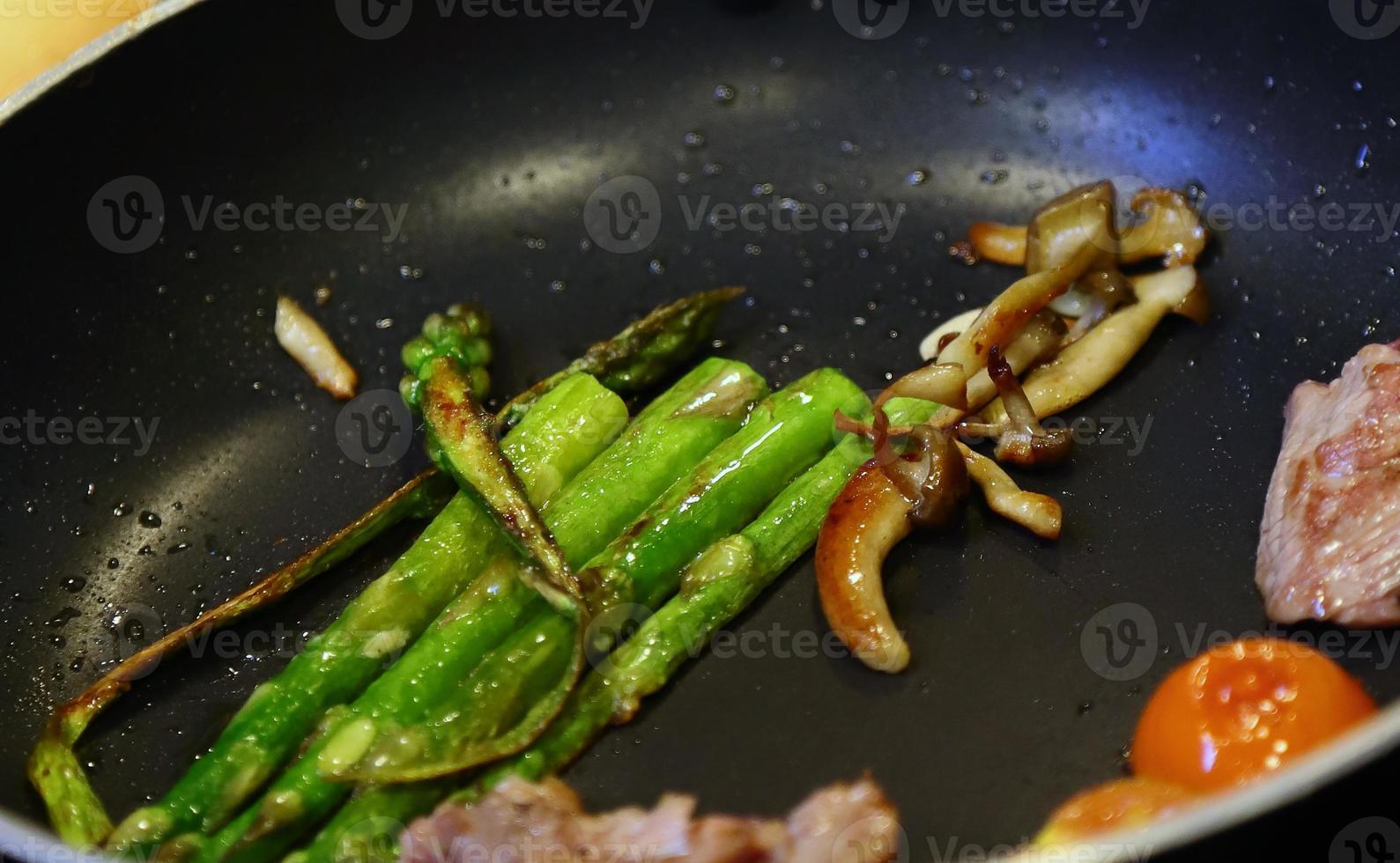 Roasted asparagus and beef meat photo