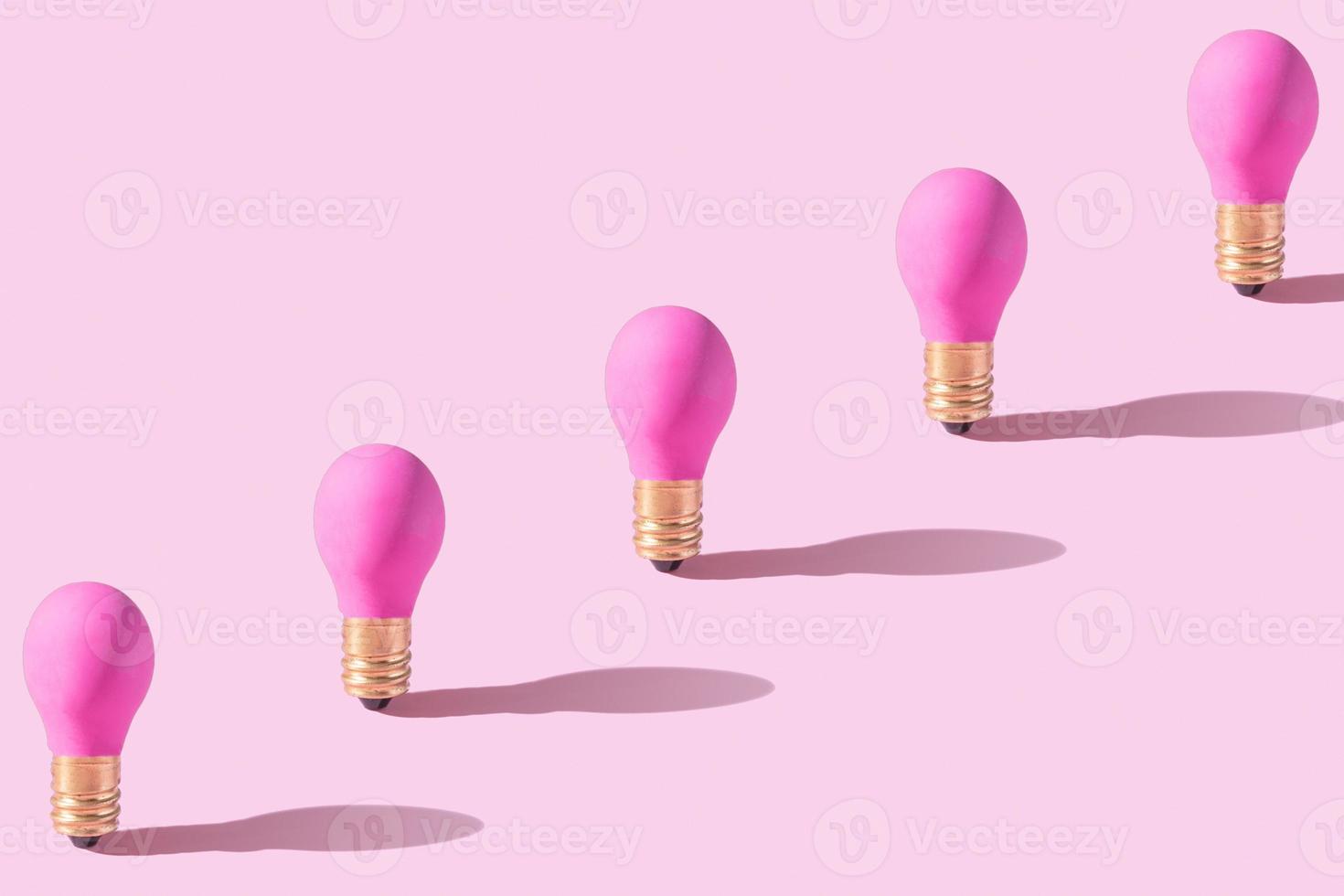 Pattern from pink lamp on pink background. Creative idea or startap concept. Monochrome photo