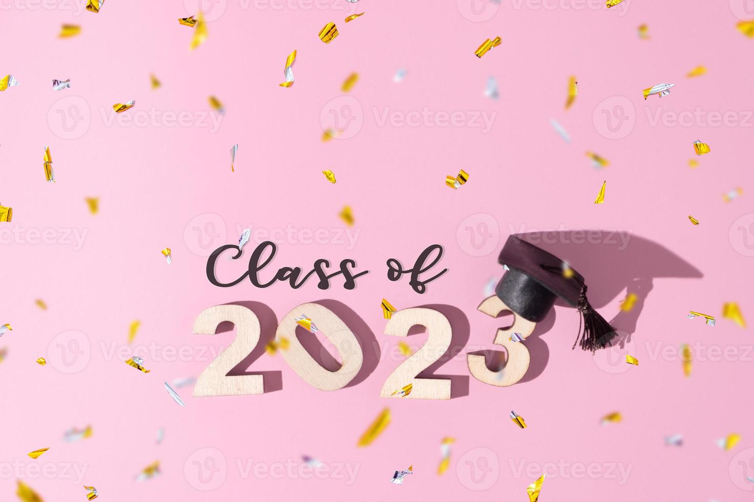 Class of 2023 concept. Numbers 2023 with black graduated cap on colored background photo