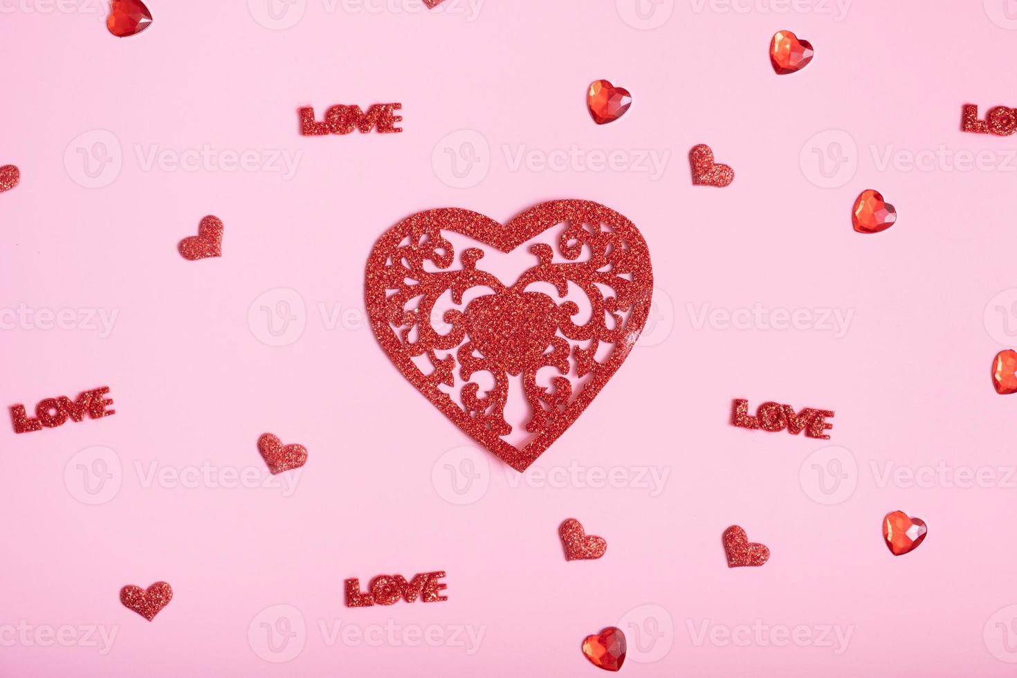 Glitter red heart and small hearts on pink background. Valentines Day background photo