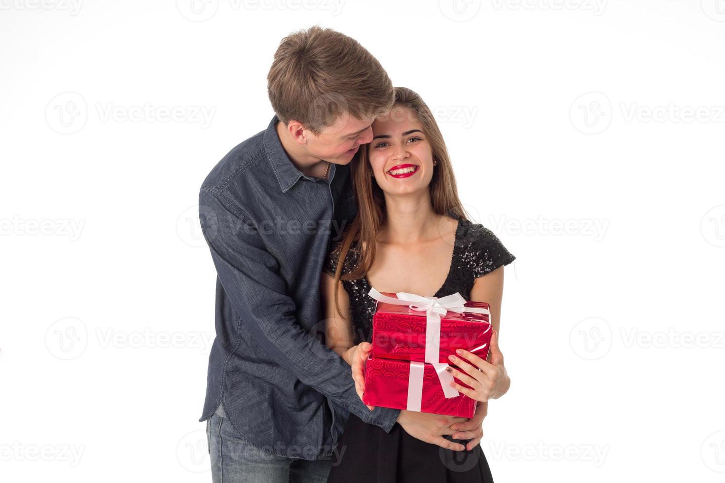 cheerful young couple with gift in hands photo