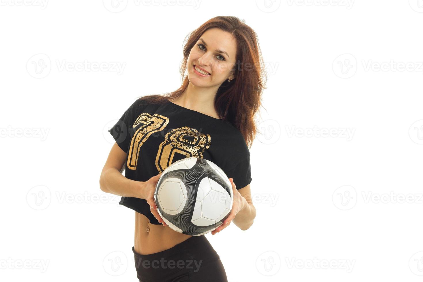 cute girl looks forward to smiling and holding a soccer ball photo