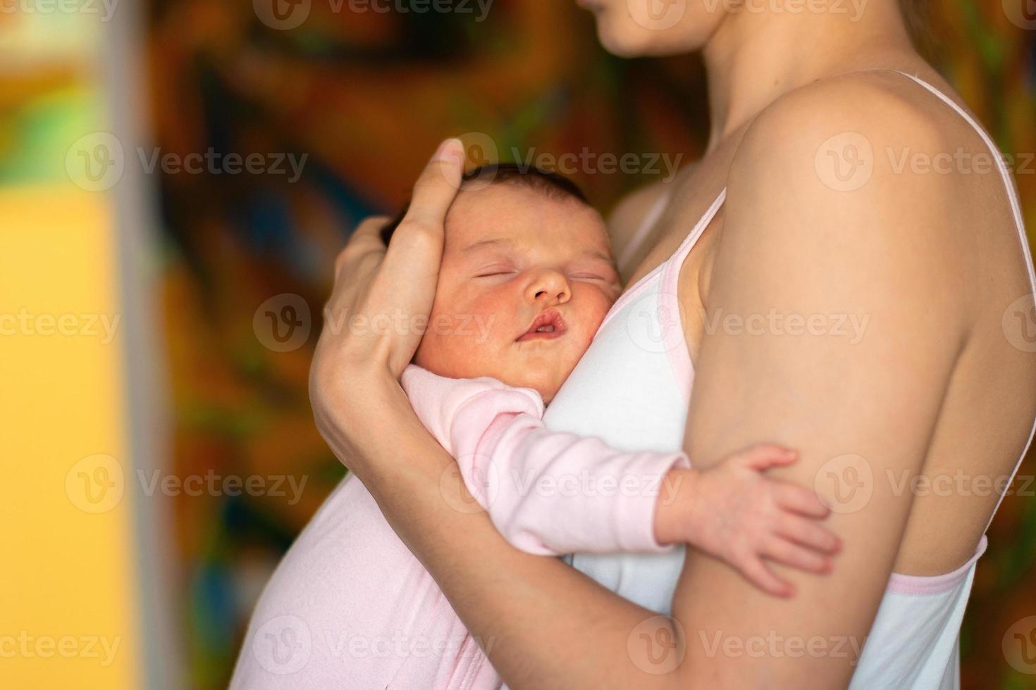 little baby girl sleeps in mother hands photo