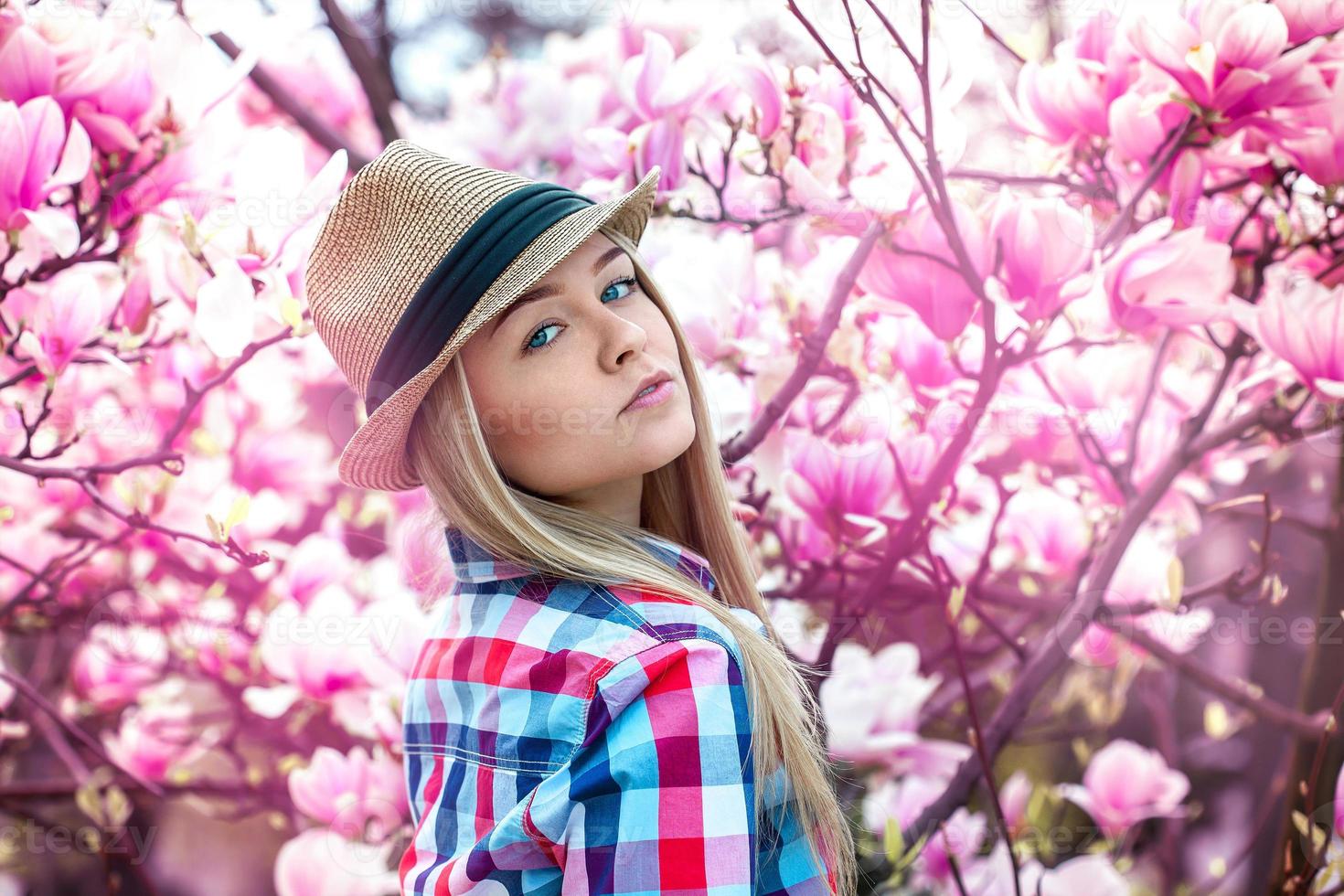 Beautiful young sexy blonde with floowers looking at camera photo