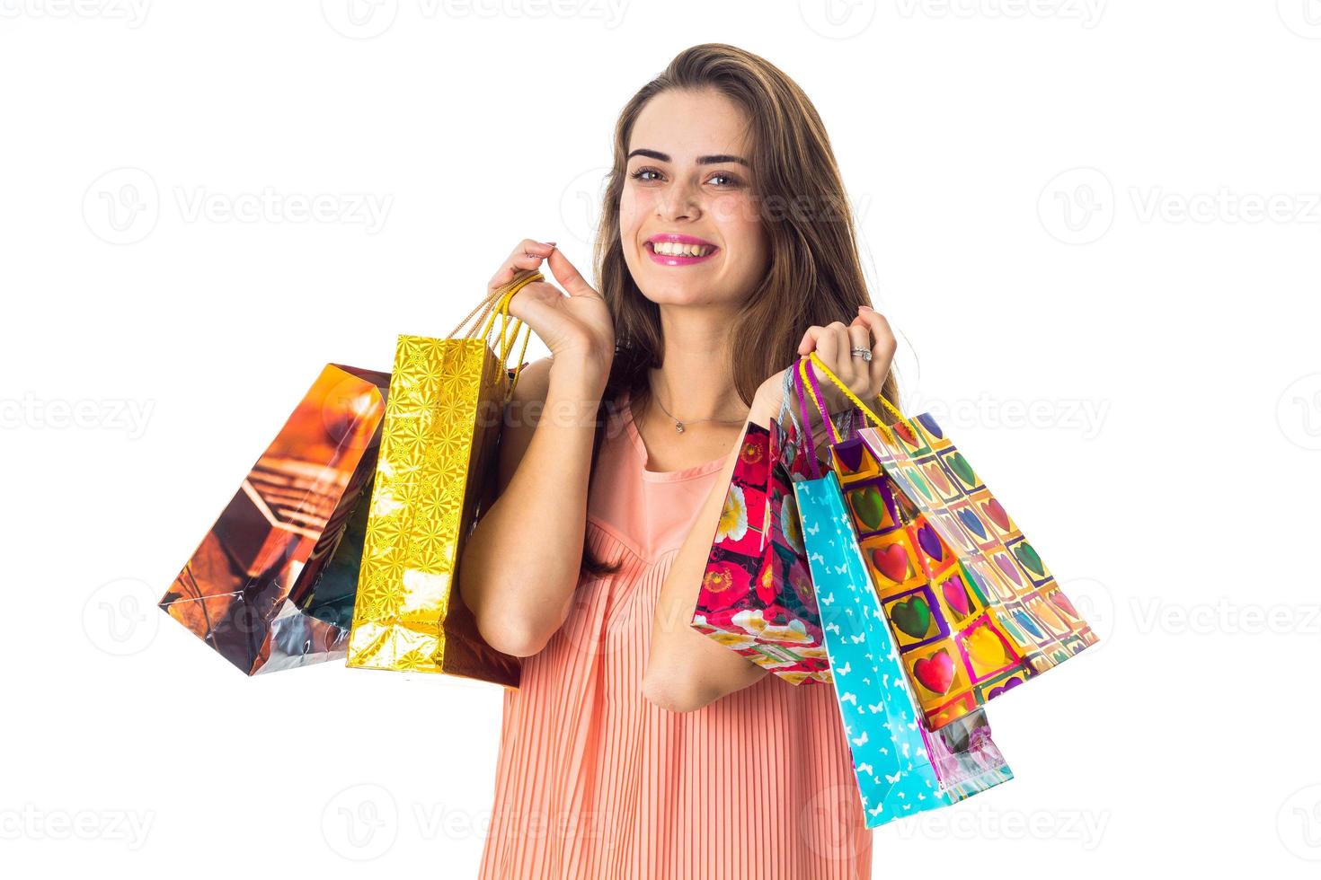 young cute girl keeps in two hands shopping bags photo