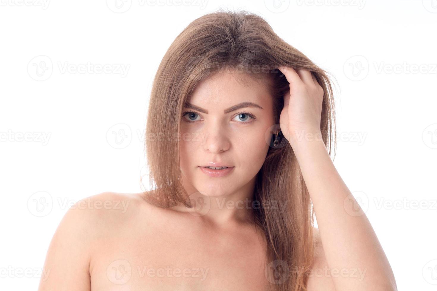 Portrait of a beautiful girl without makeup that keeps hand hair closeup photo