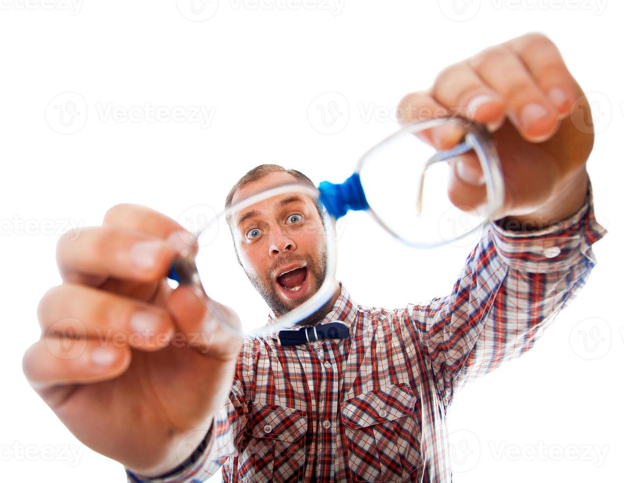 cheerful geek stares through his glasses photo