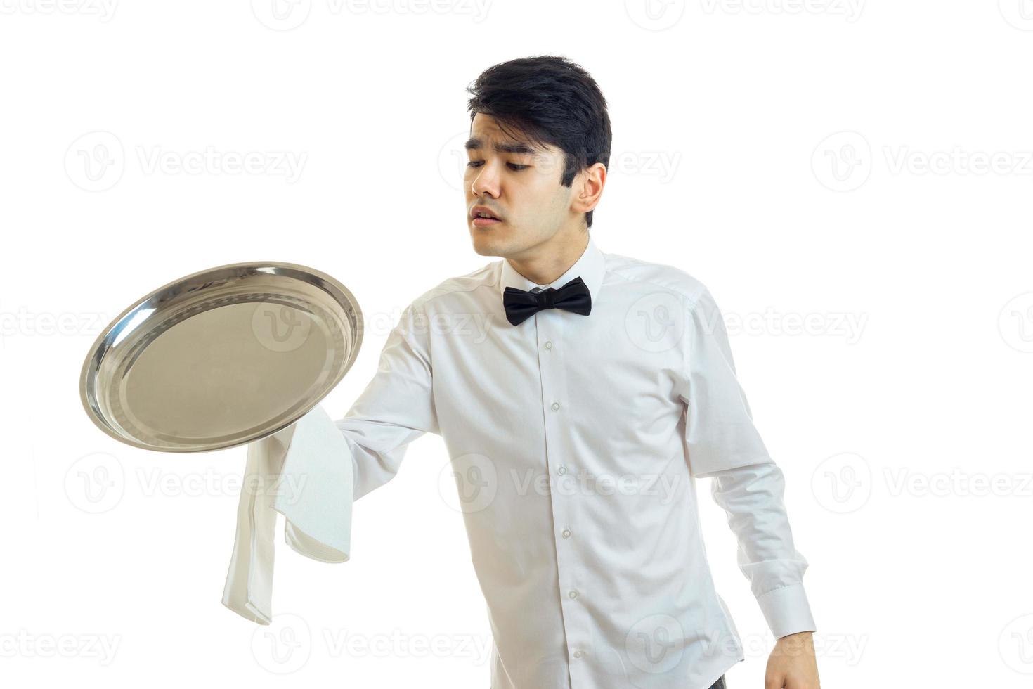 young handsome waiter holding a large tray for Cookware photo