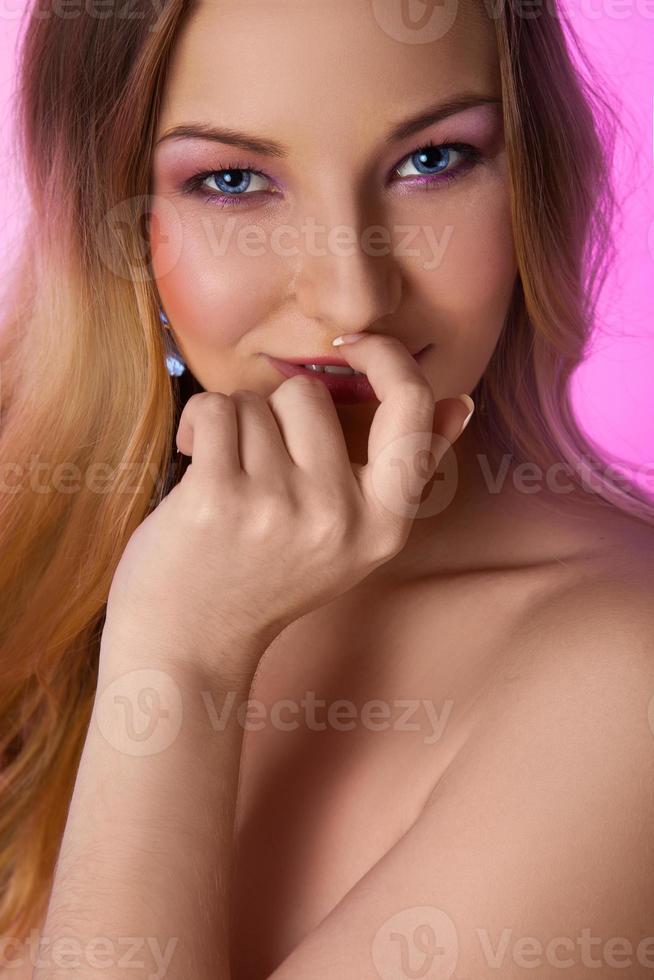 Beautiful blonde woman with blue eyes in studio photo