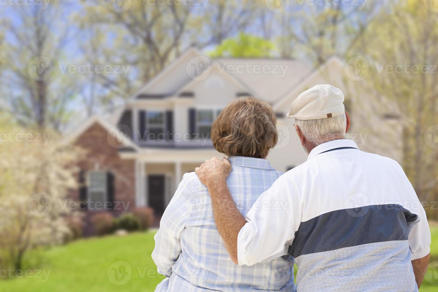 Happy Senior Couple Looking at Front of House photo