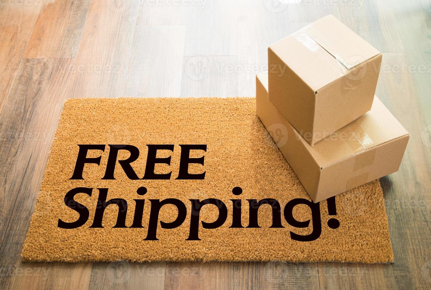 Free Shipping Welcome Mat On Wood Floor With Shipment of Boxes photo