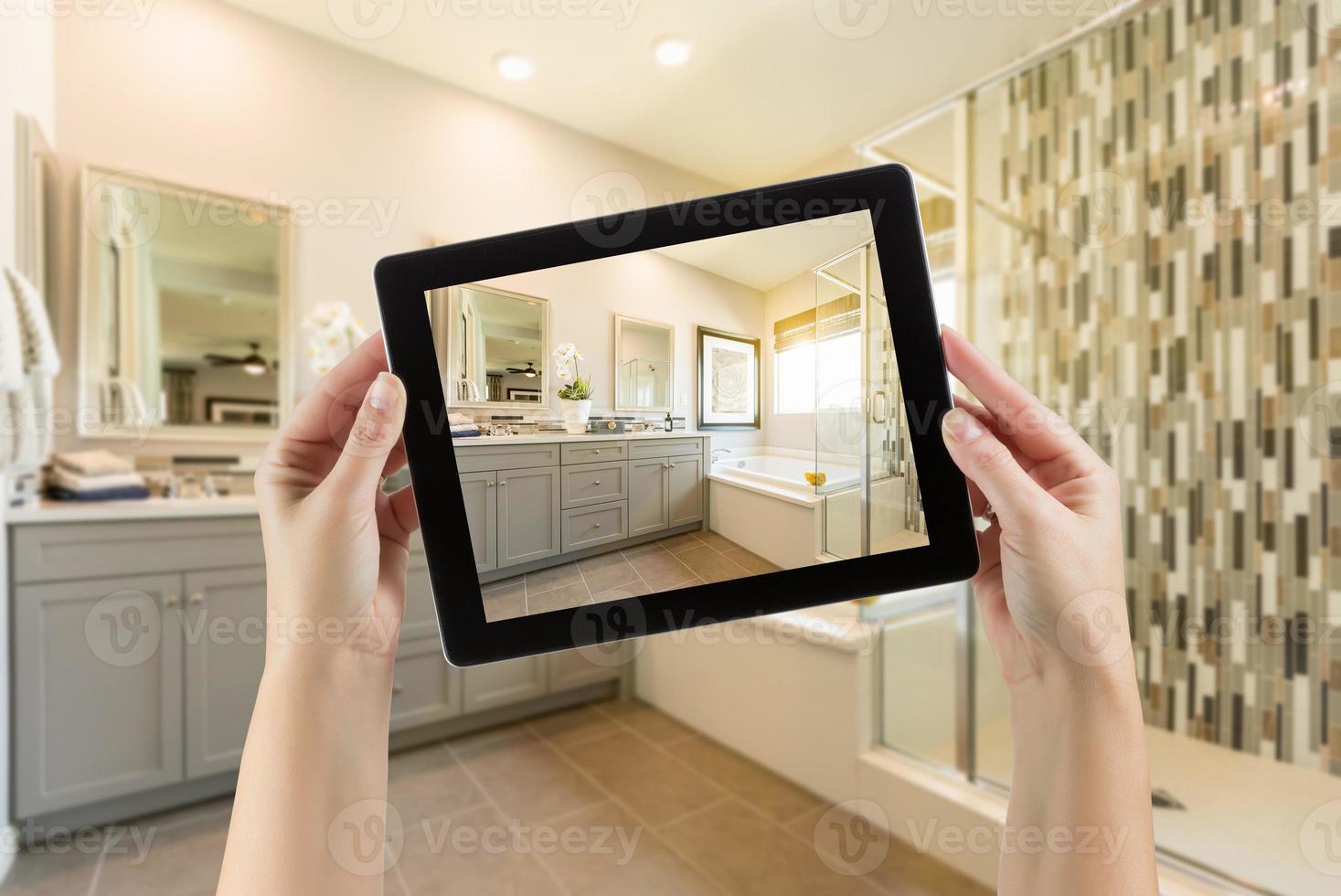 Master Bathroom Interior and Hands Holding Computer Tablet with Photo on Screen
