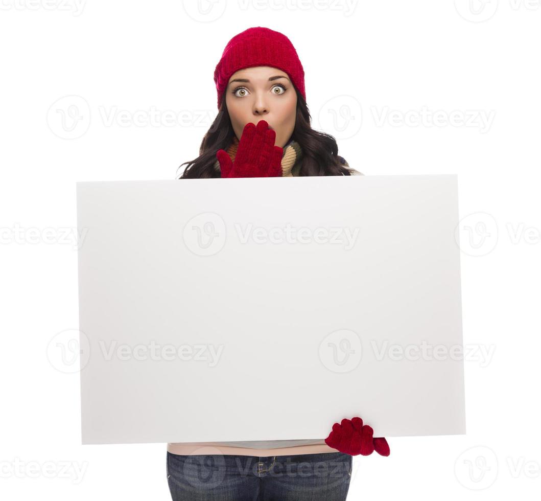 Stunned Girl Wearing Winter Hat and Gloves Holds Blank Sign photo