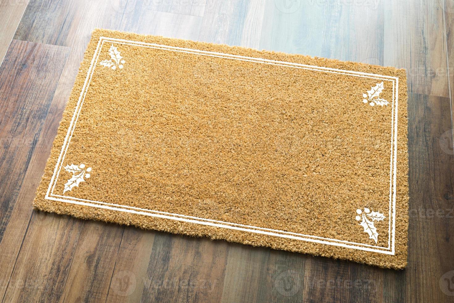 Blank Holiday Welcome Mat With Holly On Wood Floor Background photo