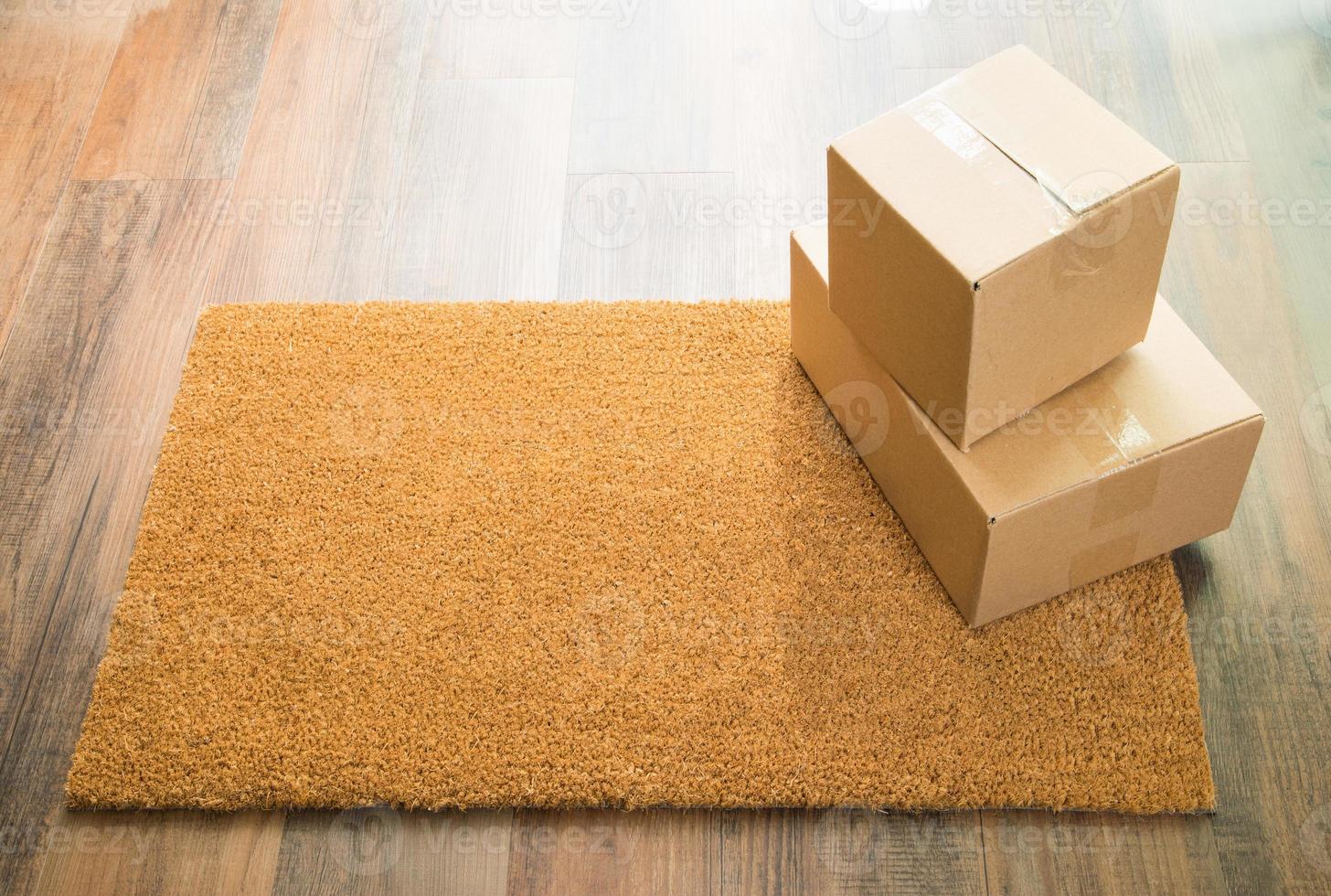 Blank Welcome Mat On Wood Floor With Shipment of Boxes photo
