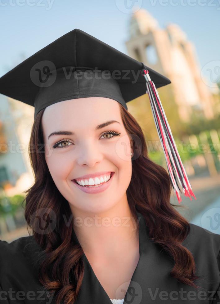 Happy Graduating Mixed Race Woman In Cap and Gown photo