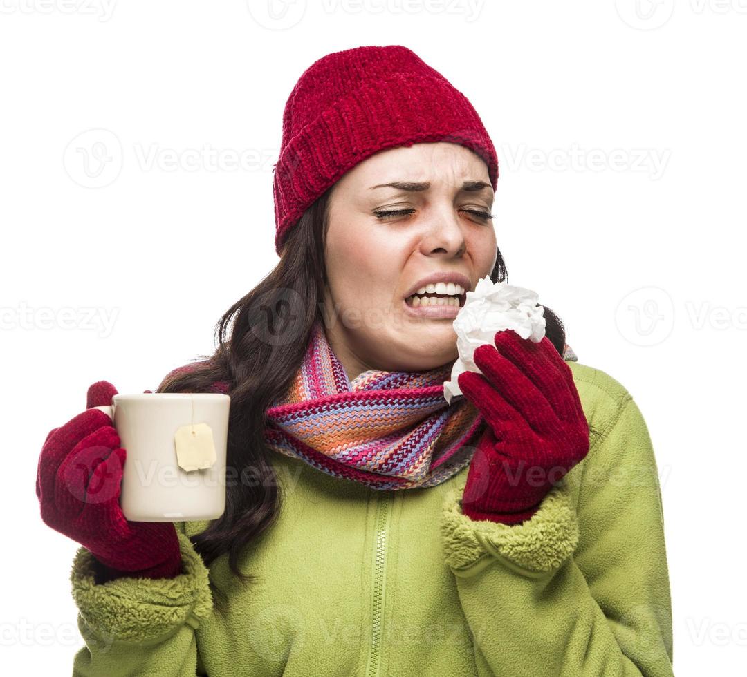 Sick Mixed Race Woman Drinks Hot Tea While Blowing Nose photo