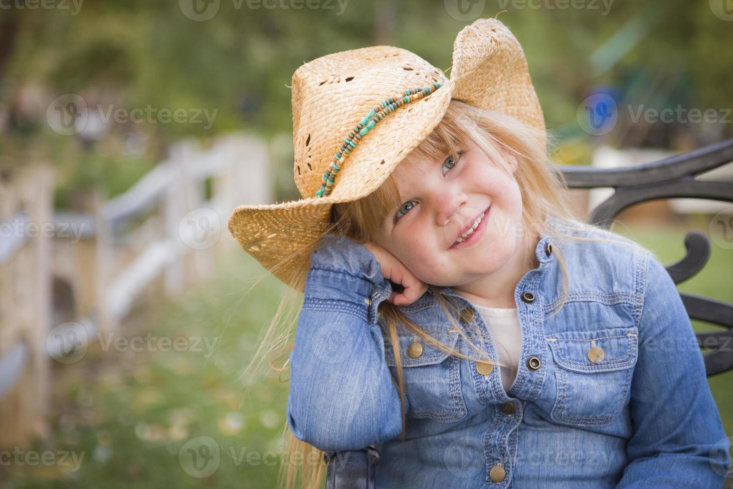 Cute Young Girl Wearing Cowboy Hat Posing for Portrait Outside photo