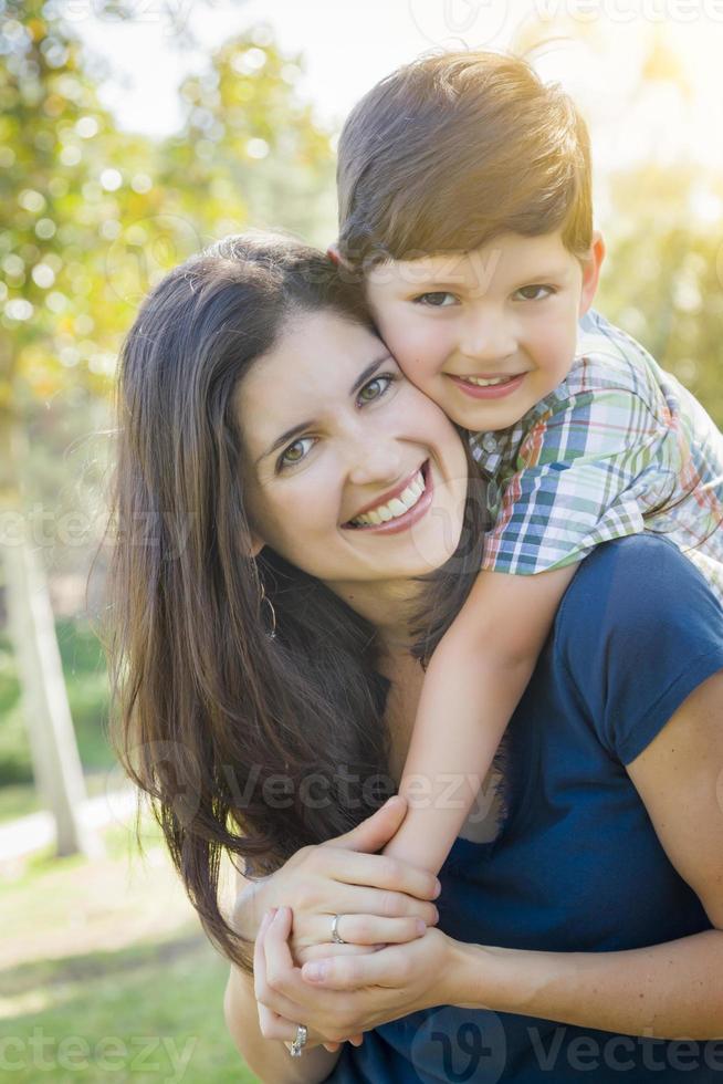 Attractive Mixed Race Mother and Son Hug in Park photo