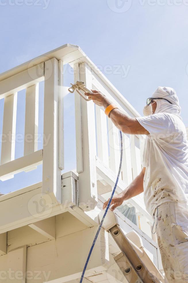House Painter Spray Painting A Deck of A Home photo