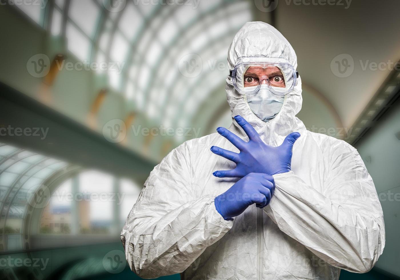 Man With Intense Expression Wearing HAZMAT Protective Clothing Inside Building photo