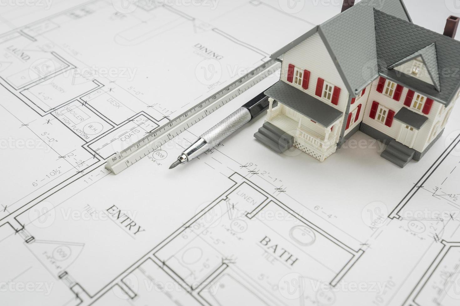 Model Home, Engineer Pencil and Ruler Resting On House Plans photo