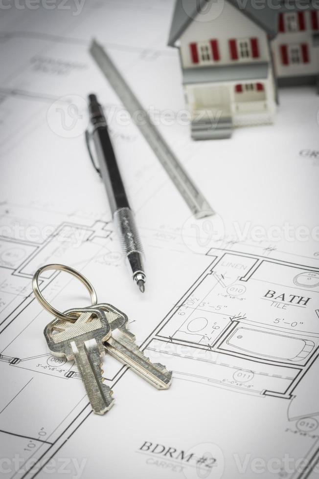 Home, Pencil, Ruler and Keys Resting On House Plans photo