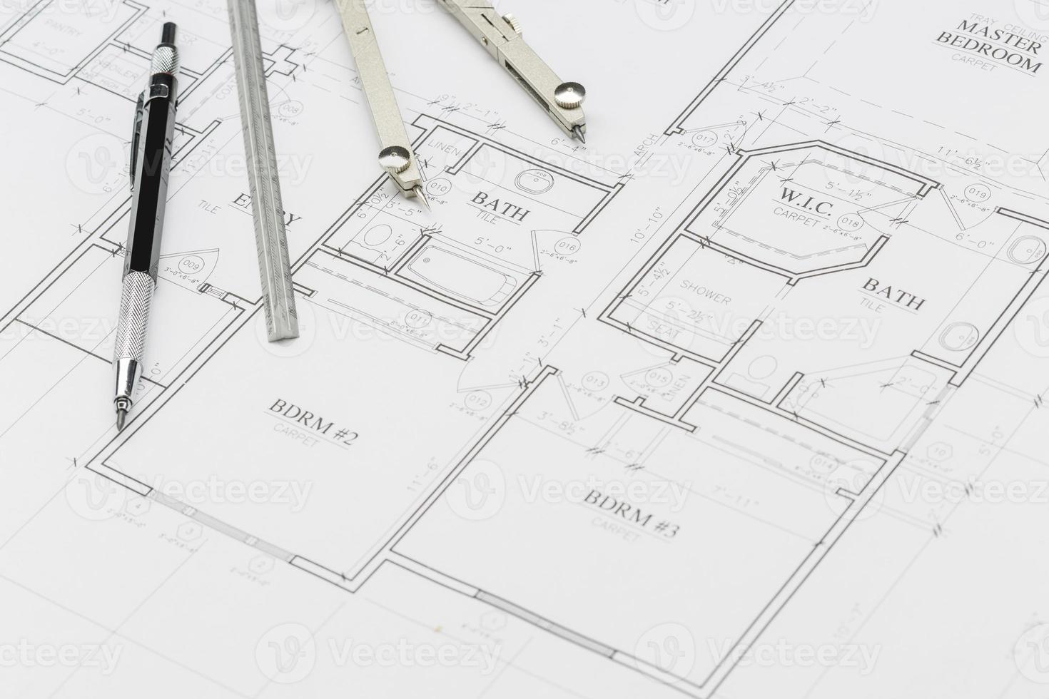 Engineer Pencil, Ruler and Compass Resting on House Plans photo