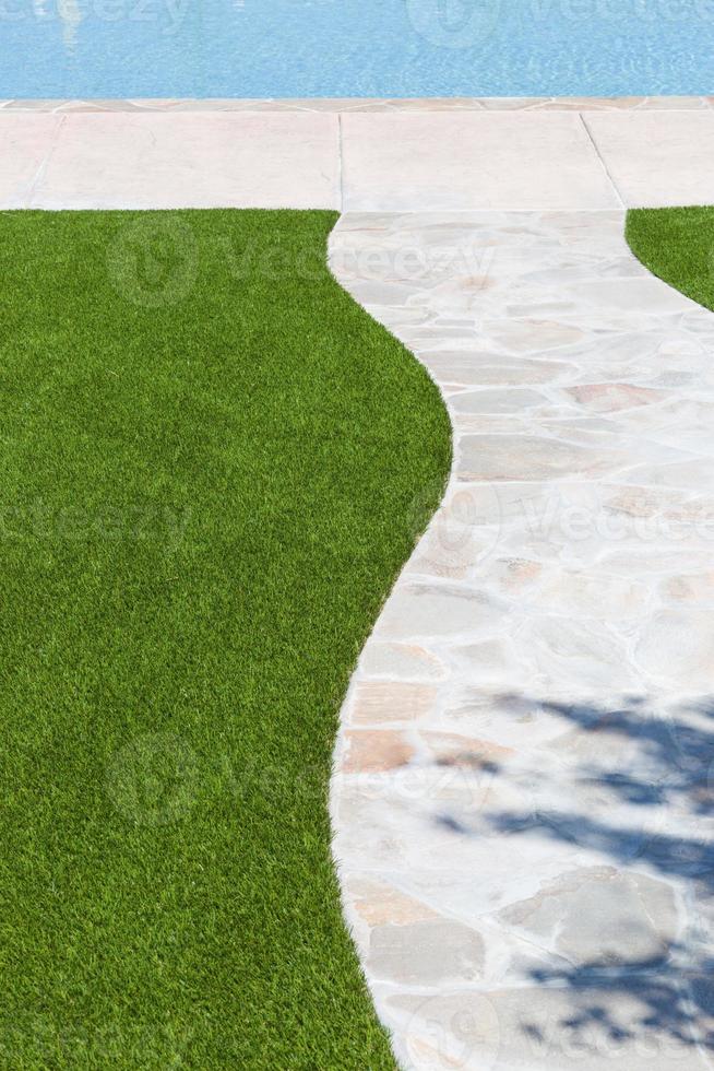New Artificial Grass Installed Near Walkway and Pool. photo