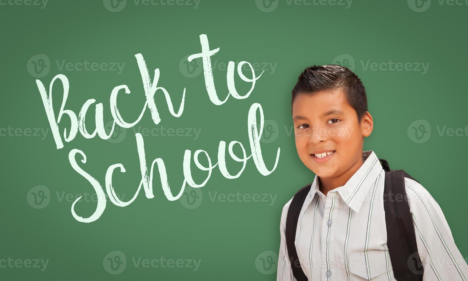 Hispanic Boy In Front of Back To School Chalk Board photo