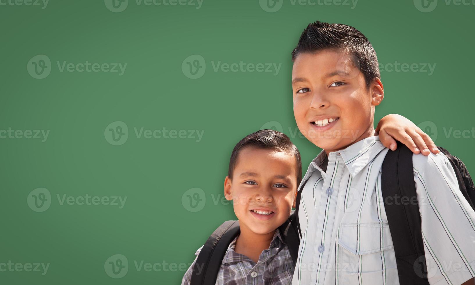 Cute Hispanic Boys In Front of Blank Chalk Board photo