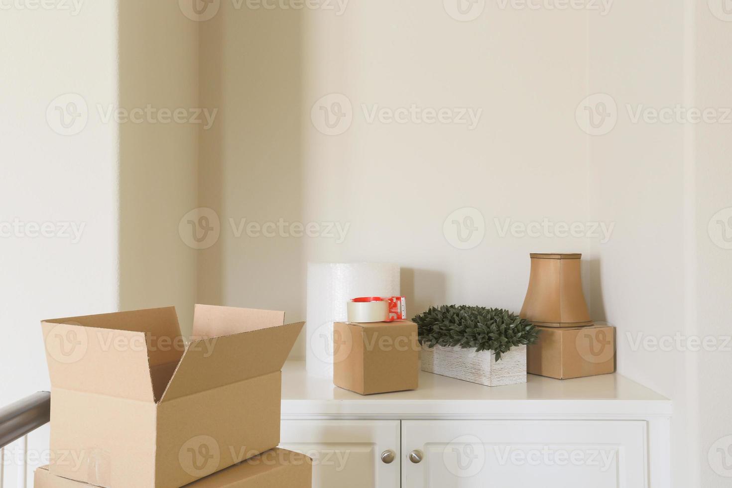 Variety of Packed Moving Boxes In Empty Room photo