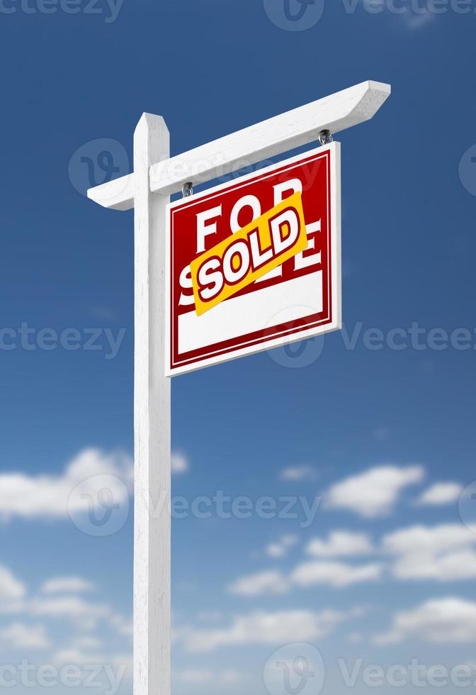 Right Facing Sold For Sale Real Estate Sign on a Blue Sky with Clouds. photo