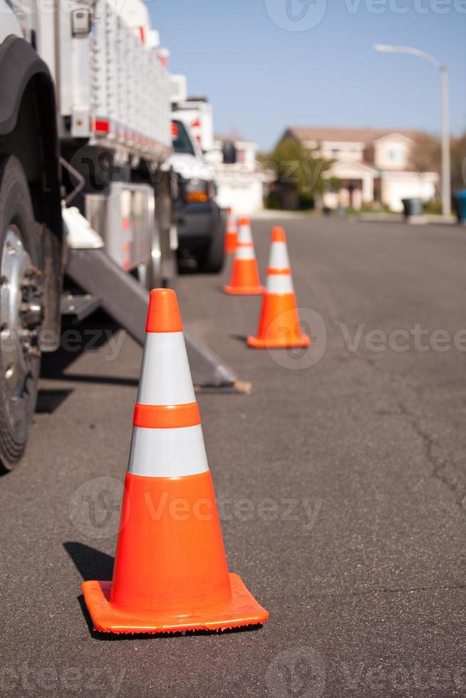 Orange Hazard Cones and Utility Truck in Street photo