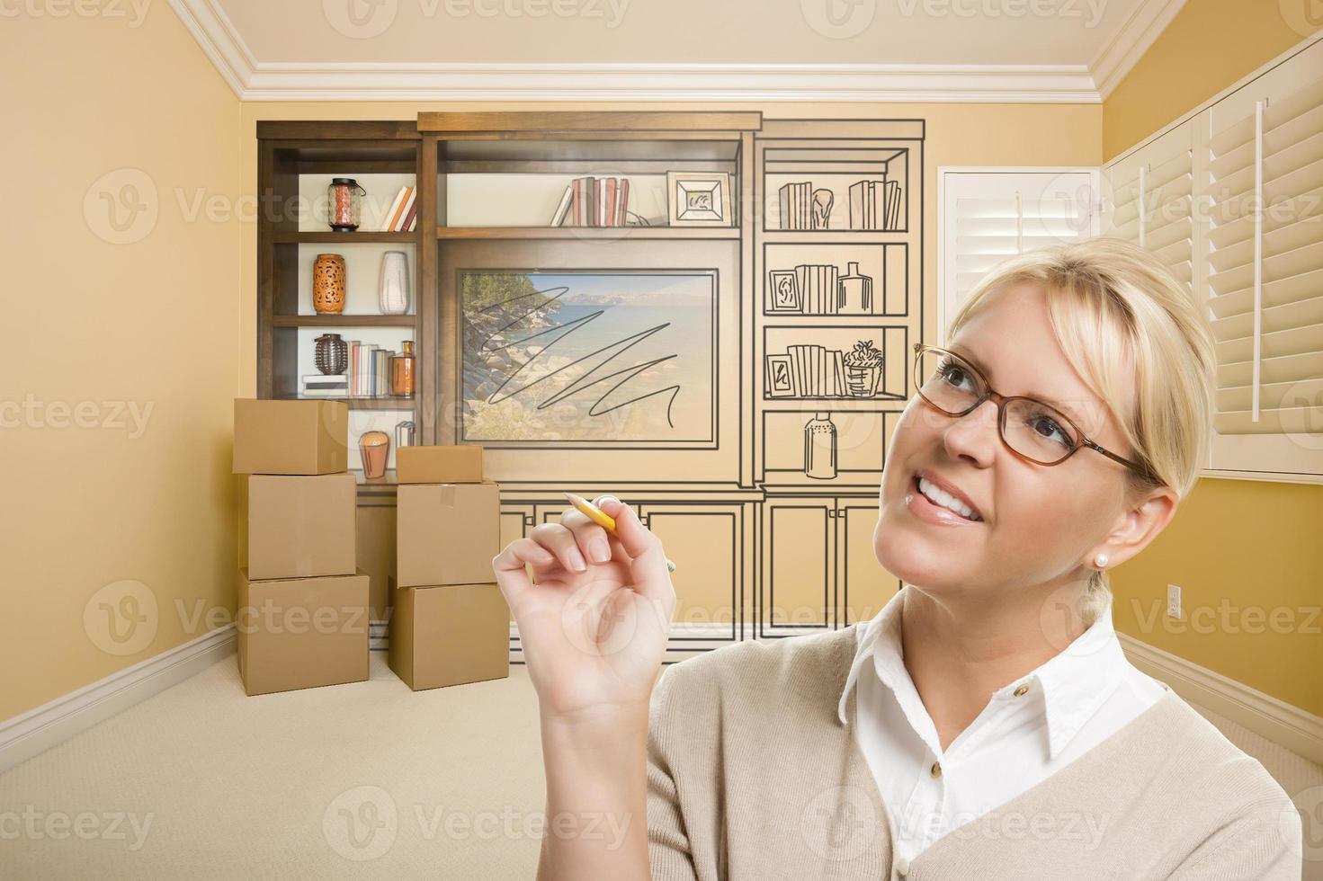 Female Holding Pencil In Room With Drawing of Entertainment Unit photo