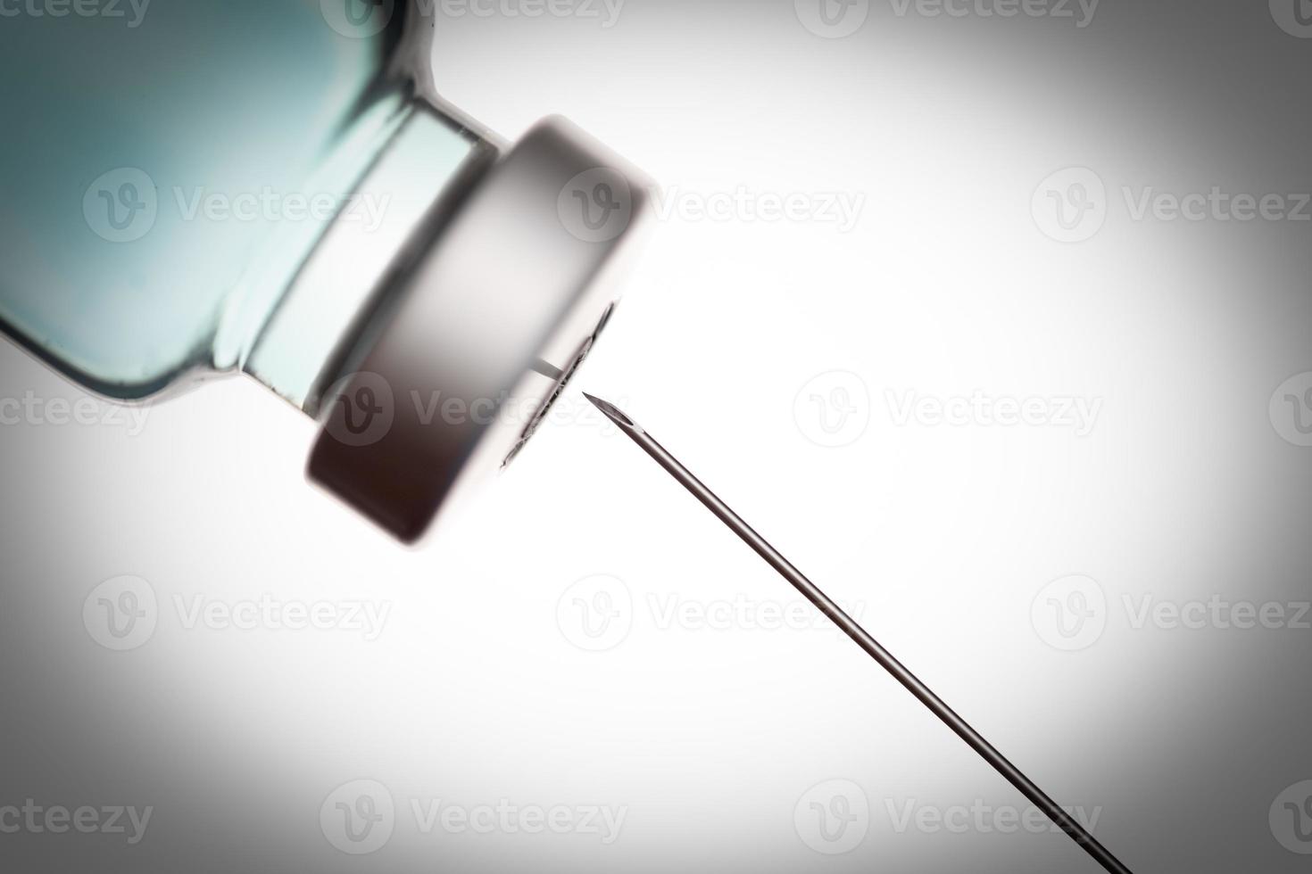 Medical Syringe Needle and Vaccine Vial Against White Background photo