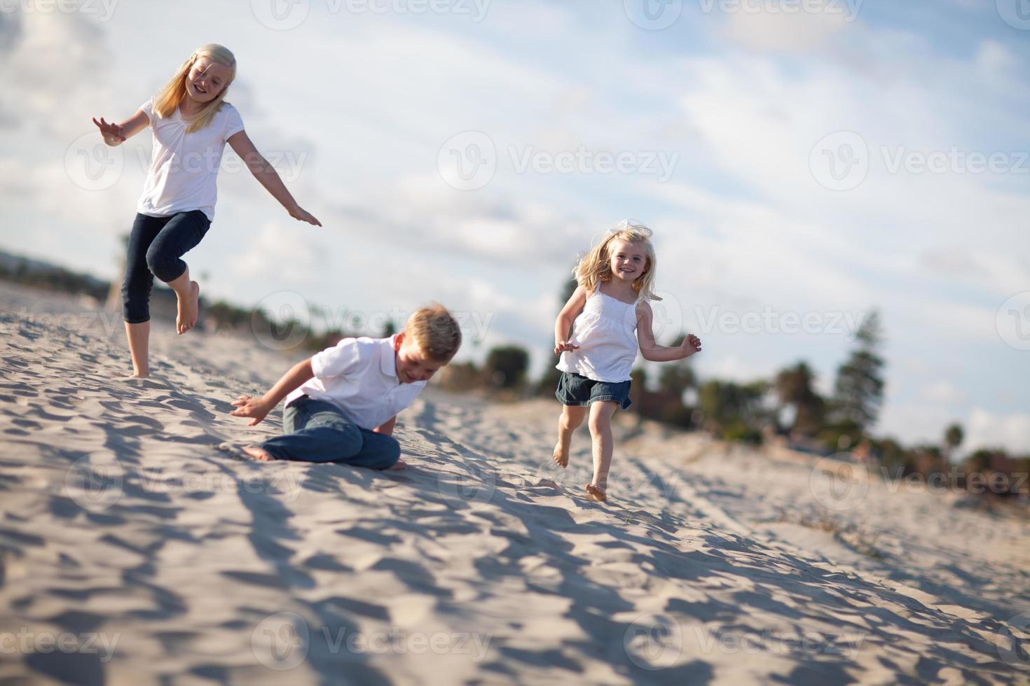 Adorable Brother and Sisters Having Fun at the Beach photo
