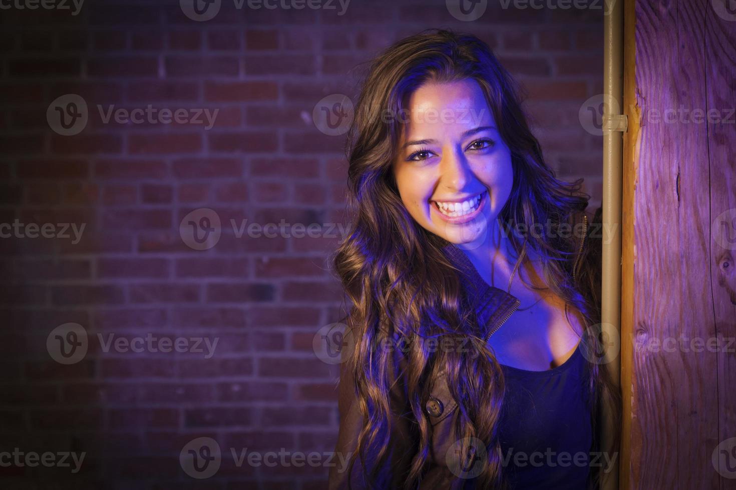 Pretty Mixed Race Young Adult Woman Against a Brick Wall photo