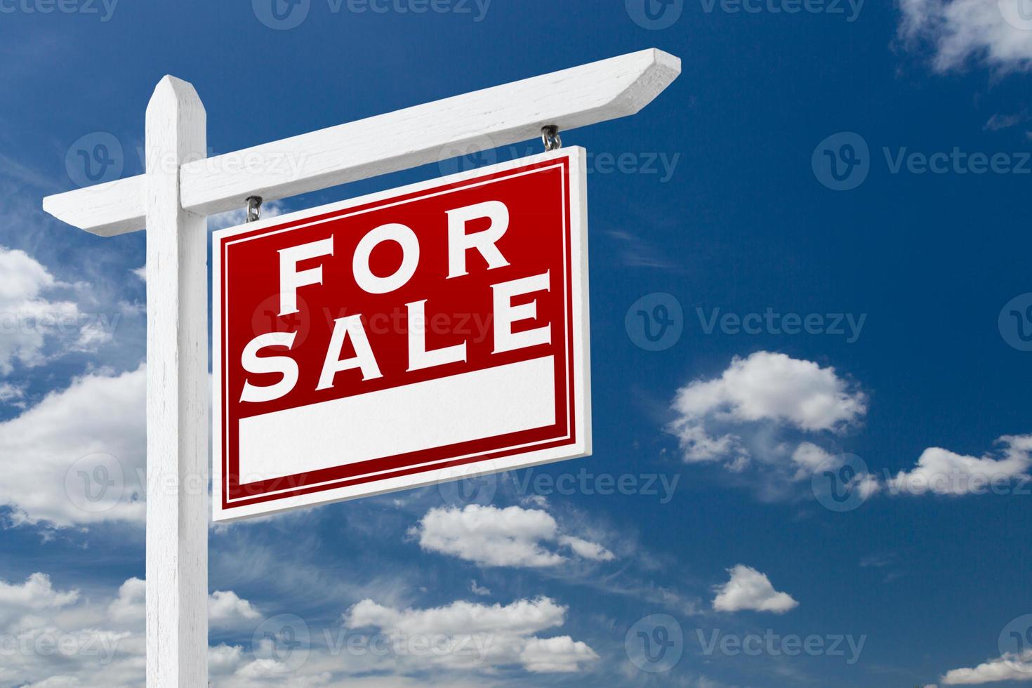 Right Facing For Sale Real Estate Sign Over Blue Sky and Clouds With Room For Your Text. photo