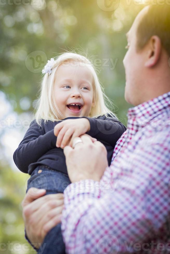 Adorable Little Girl Having Fun With Daddy Outdoors photo